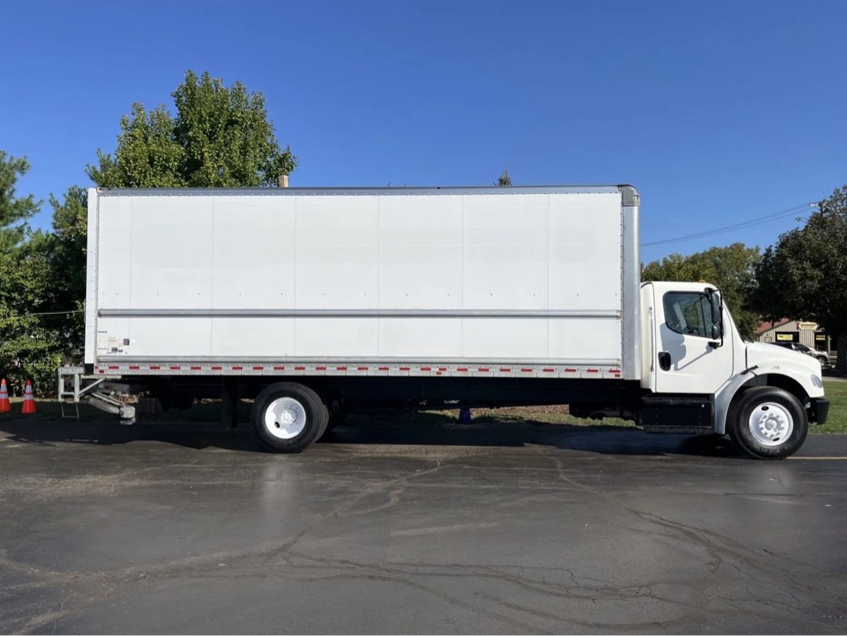 Clean white 26-foot box truck in side profile under a blue sky